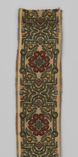 Curtain galloon of woven imitation Berlin embroidery, displaying cartouches standing on a grey ground with green borders and dark red rosette flowers.