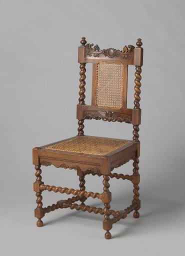 Chair with rattan seat and back. Lower rail decorated with carved winged angel figures