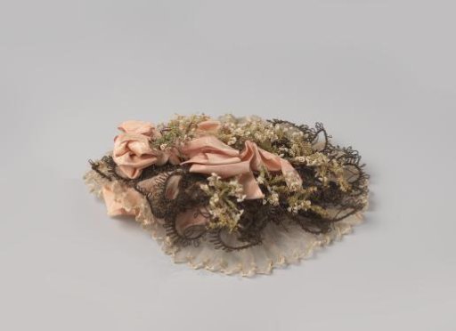 Hat of black brass, pink silk gauze, pink moiré bows and artificial flowers