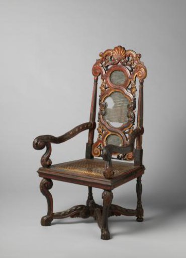 Armchair of Polychrome Teak with Loose Seat Frame. Decorated with Carved Leaves, Volututes, Rosettes, and Braiding with Leaf Volututes. Back Crowned with a Palmette with Volututes and Leafwork