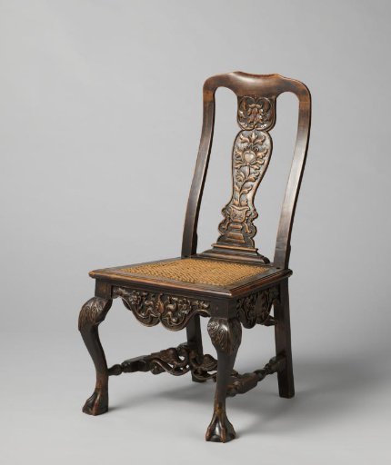 Chair with a high back, with carved decorations and upholstered with cane
