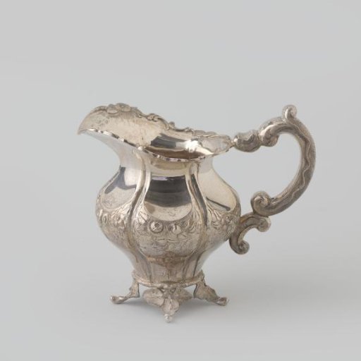 Milk can of silver, six-lobed body on four legs in the form of curved branches. C-shaped handle and wide spout.
