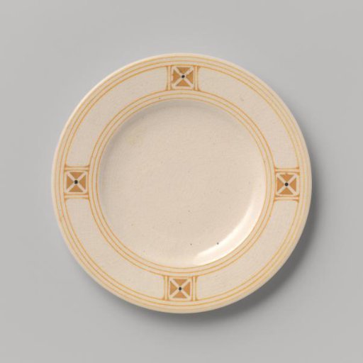 Cake plate decorated with a block pattern and dots in yellow and black