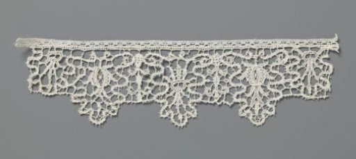 Strip of needle lace with pomegranate and sunburst wreath in oak leaves