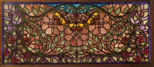 Transom of stained glass with blooming plants