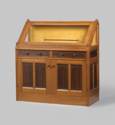 Display cabinet with a rear-opening flap