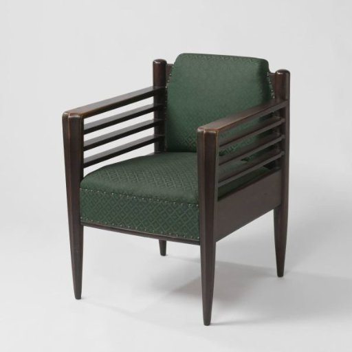 Armchair upholstered with a green artificial covering and with side walls consisting of three flat rows lying one above the other