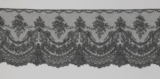 Japanese strip of black bobbin lace with oval cartouches and rose garlands