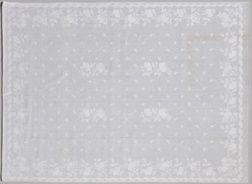 Tablecloth of white linen damask with rose pattern