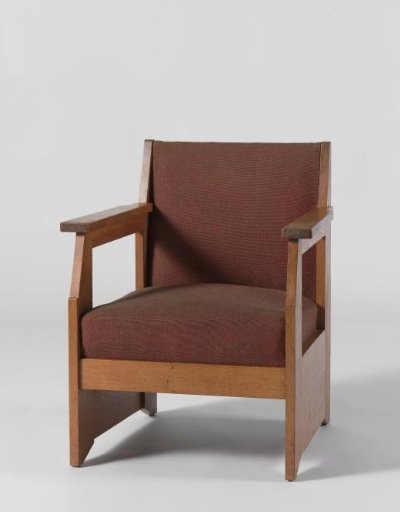 Armchair with broad side panels and upholstered in red wool
