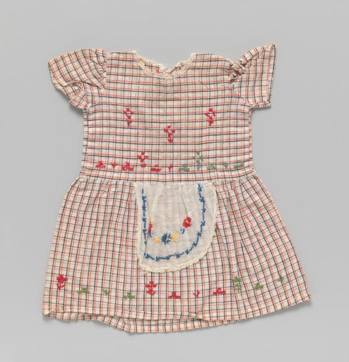 Dress of checked cotton with attached apron; all embroidered with flowers