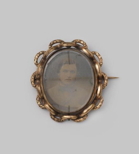 Brooch with a photograph of a young man
