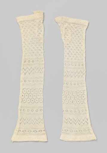 Mitten of white openwork knitting, with a cut-off thumb