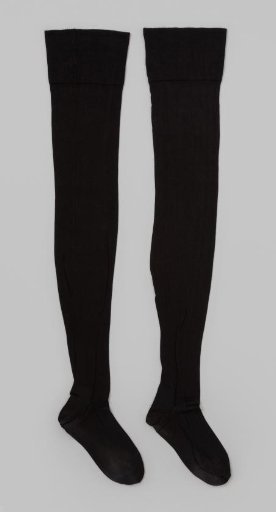 Stocking of plain black silk tricot with a narrow vertical line on the seam and a wide border with small notches along the edge