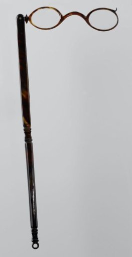 Lorgnet with frame of tortoiseshell or celluloid on long octagonal handle with fluting halfway down and at the bottom
