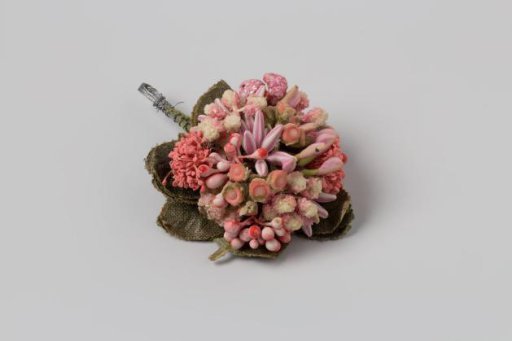 Corsage with pistils and stamens on stalks in rose, white, and lilac