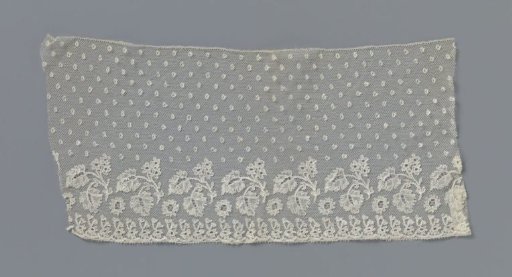 Strip of bobbin lace with blossom branches under a wide band of mosses