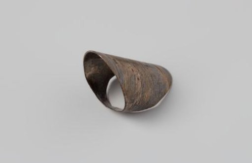 Silver thimble, in the form of a flat ring with a broad nail-protecting upper part