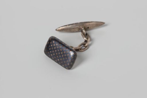Rectangular cufflink of nielloed silver with a block pattern