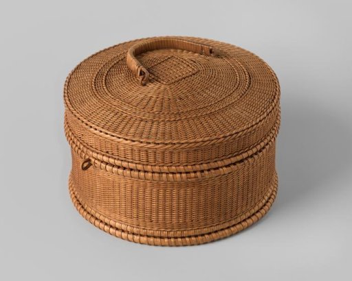 Sewing cushion of woven straw, covered with bright blue pongee silk; quilted and stitched