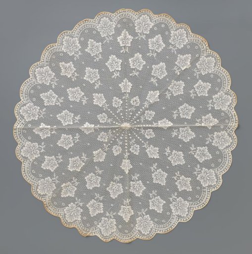 Parasol top of white machine-made lace (cotton?), with a pattern of scattered geranium leaves