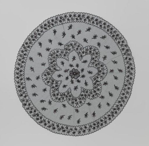 Parasol canopy of black tulle decorated with black tambour work in the form of straw flowers, a central star, and a floral scroll