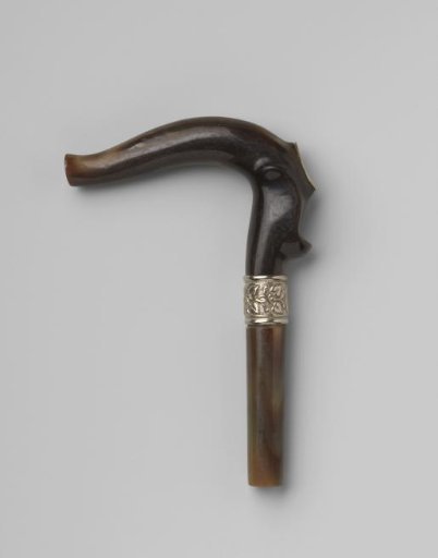Handle of black horn with a curved knob bearing a silver-colored oval-shaped plate