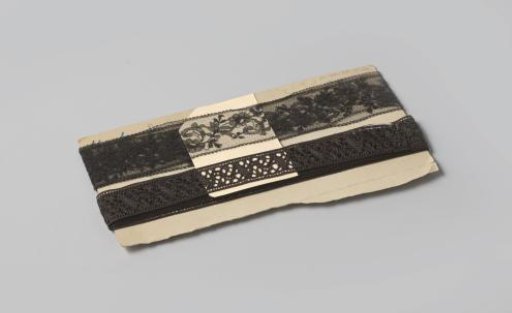 Insert of shiny black machine-made lace, on cardboard