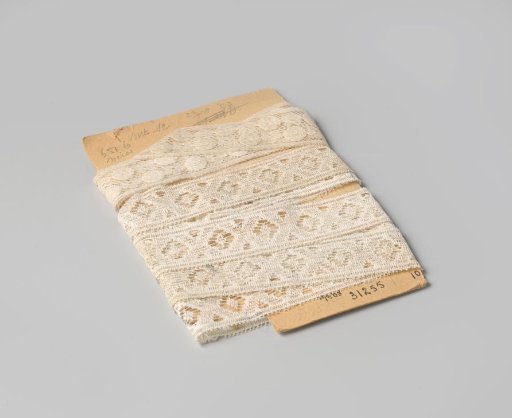 Insert of white machine-made lace with St. Andrew's crosses, on cardboard