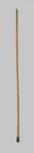 Handle of a bamboo parasol or umbrella with teardrop-shaped plastic knob and metal point