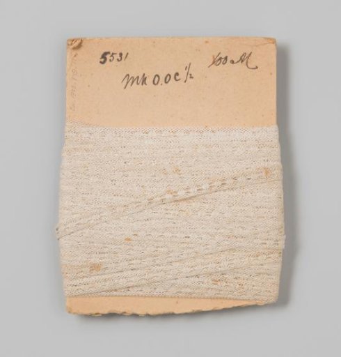 Insert of white lace on cardboard