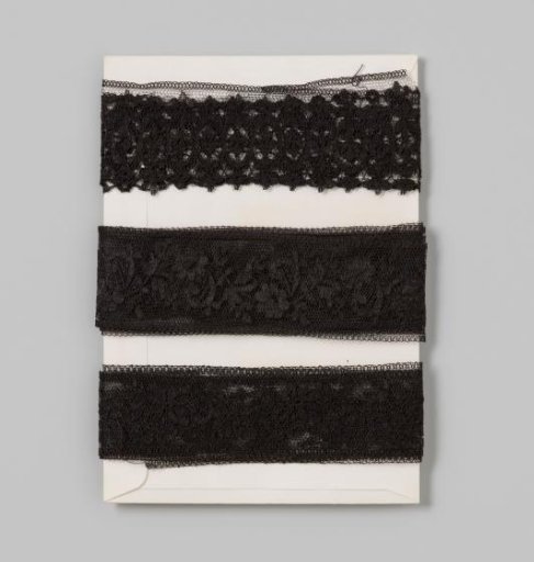 Doorstop of black tulle with floral and leaf motif