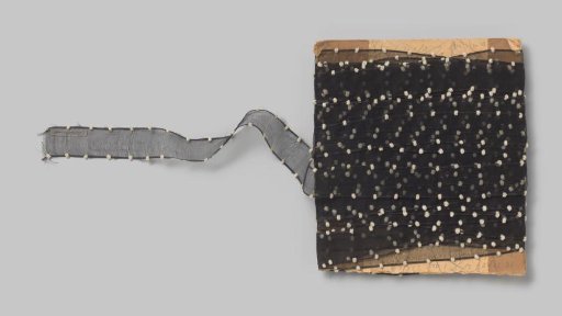 Board with a black ribbon of silk gauze, with a white velvet ball at each edge every two cm