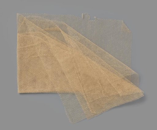 Fragment of cream-white coarse cotton tulle