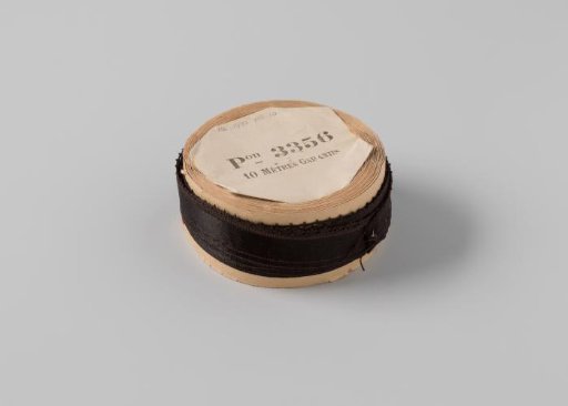 Ribbon on a roll, black satin with one side featuring picots