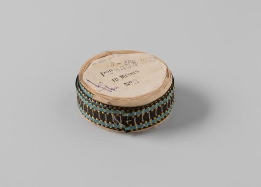 Ribbon on a roll, with a black stripe in the center, flanked on both sides by a blue stripe bordered on both sides by alternating yellow and black stripes, with a white stripe running across