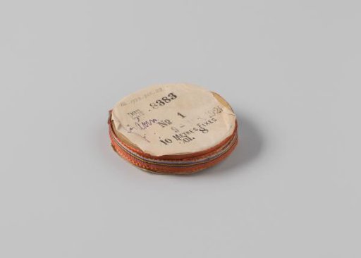 Ribbon on a roll, striped, reddish-brown with lilac, black, light green and orange