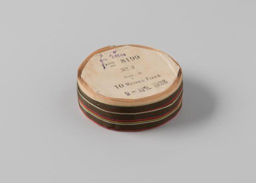 Ribbon on a roll, army green, with woven stripes in the center in magenta, black, yellow and light blue, the edges are bordered with respectively light blue and magenta