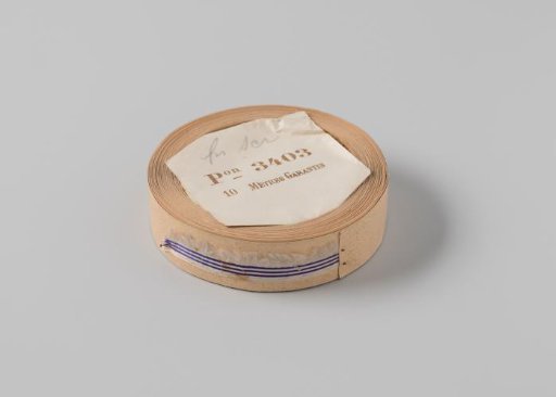 Roll with White Ribbon with One Frayed Side and Three Blue Horizontal Stripes