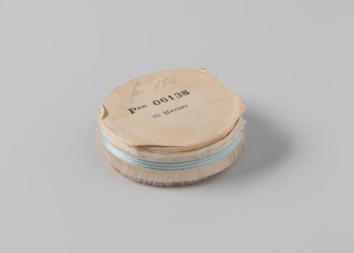 Roll with white ribbon with one frayed side and three light blue horizontal stripes