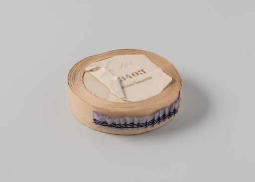 Roll with lilac ribbon with one frayed side and three black horizontal stripes