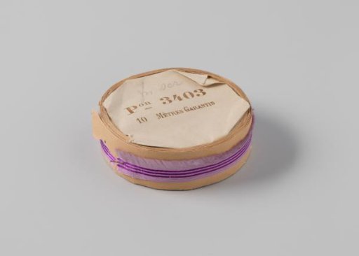 Roll with a lilac ribbon with one frayed side and three purple horizontal stripes