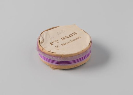 Roll with a lilac ribbon with one frayed side and three purple horizontal stripes