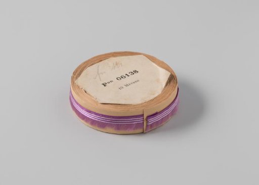 Roll with purple ribbon, one frayed side, and three white horizontal stripes