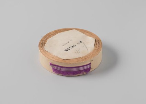 Roll with a purple ribbon with one frayed side and three white horizontal stripes