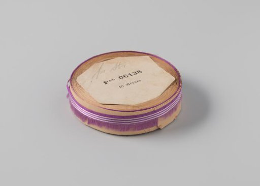 Roll of purple ribbon with one frayed side and three white horizontal stripes