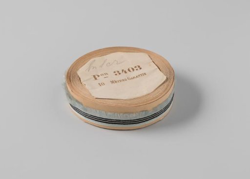 Roll with a light blue ribbon with one frayed side and three black horizontal stripes