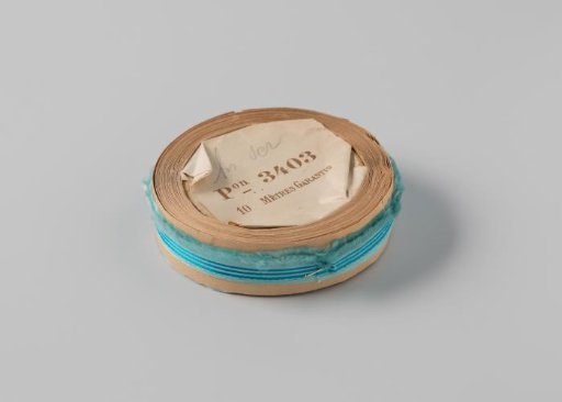 Roll with Light Blue Ribbon with One Frayed Side and Three Blue Horizontal Stripes
