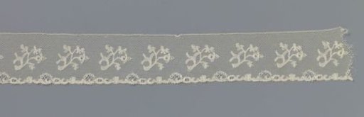 Strip of bobbin lace with loose S-shaped branches on the center line