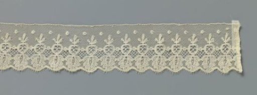 Strip of bobbin lace with hanging pomegranate
